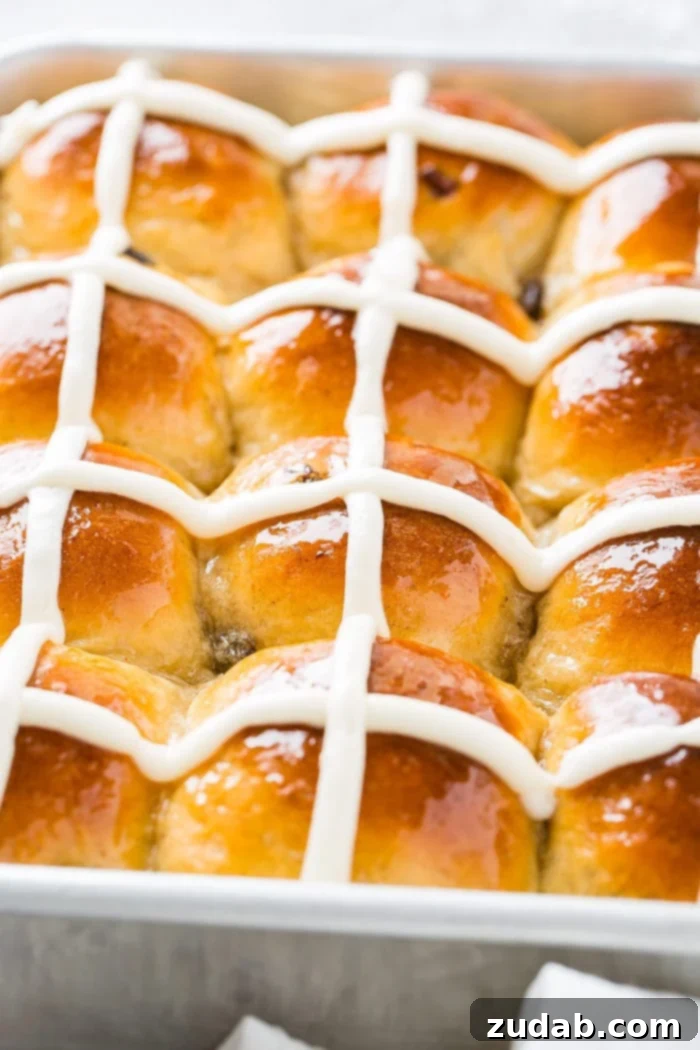 Pillowy Soft Hot Cross Buns 3 A close up photo of a pan of hot cross buns with white frosting crosses.