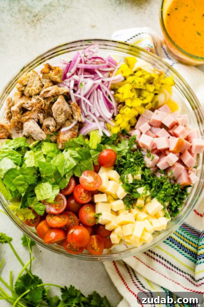 Cuban Pasta Salad 3 A photo of a large glass bowl full of all the ingredients for cuban pasta salad.