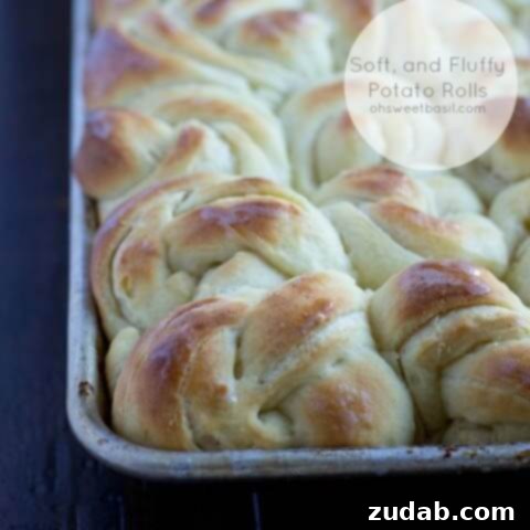 A delightful close-up of a basket brimming with soft, golden potato rolls, promising a comforting homemade treat.