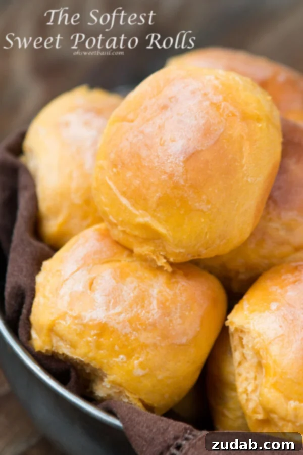 An indulgent close-up of fluffy sweet potato rolls, golden and inviting, perfect for a special meal.