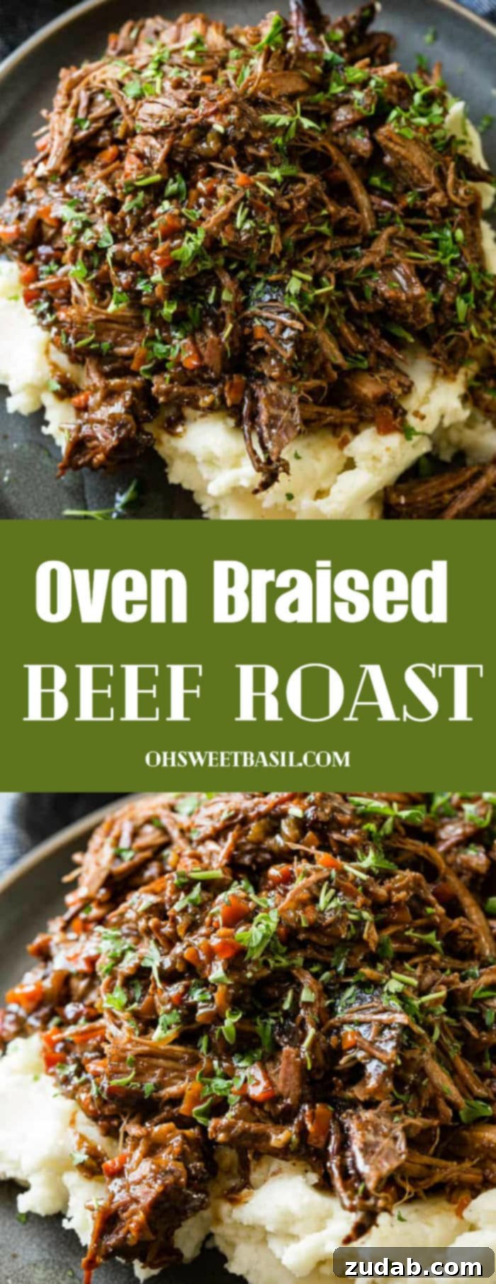 Hearty Oven-Braised Pot Roast 11 A photo of a dark gray plate with a pile of mashed potatoes on it covered in juicy shredded braised beef topped with chopped fresh parsley.