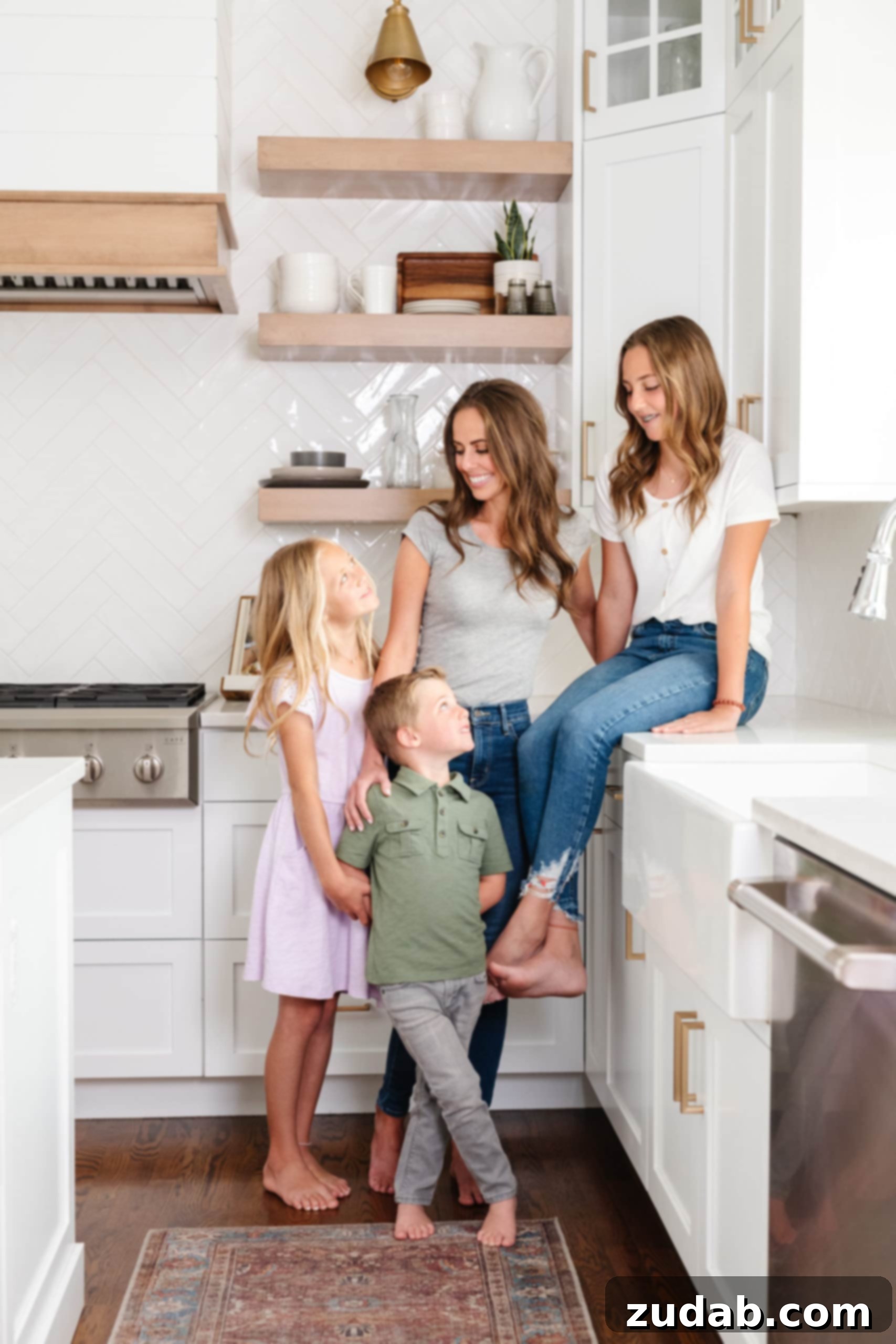 A mother with her two children in a bright, modern kitchen, laughing together as they bake or cook, representing family bonding and shared activities.