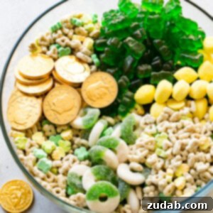 Lucky Leprechaun's 5-Minute Treat 7 A small square image of the St. Patrick's Day snack mix, featuring a colorful assortment of gold coins, Lucky Charms, lemon drops, and green gummies.