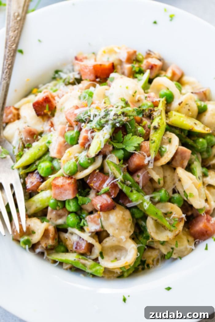 A comforting bowl of Spring Ham and Asparagus Lemon Cream Pasta, ideal for a quick weeknight dinner.