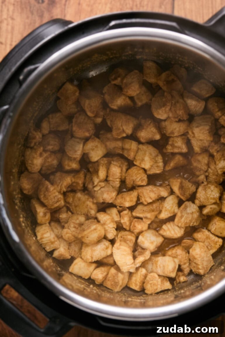 a photo of season raw chicken chunks on a plate and then the chicken chunks cooking in an instant pot