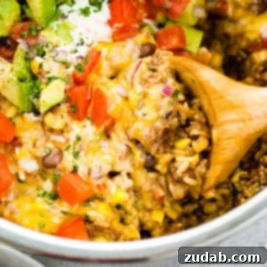 Instant Pot Ground Beef Burrito Bowls in Minutes 8 an instant pot full of ground beef and rice burrito bowls with a wooden spoon taking out a scoop