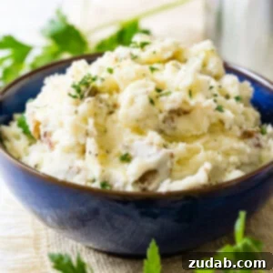 Crispy Garlic Smashed Potatoes 5 A smaller square image of creamy smashed potatoes in a blue bowl.