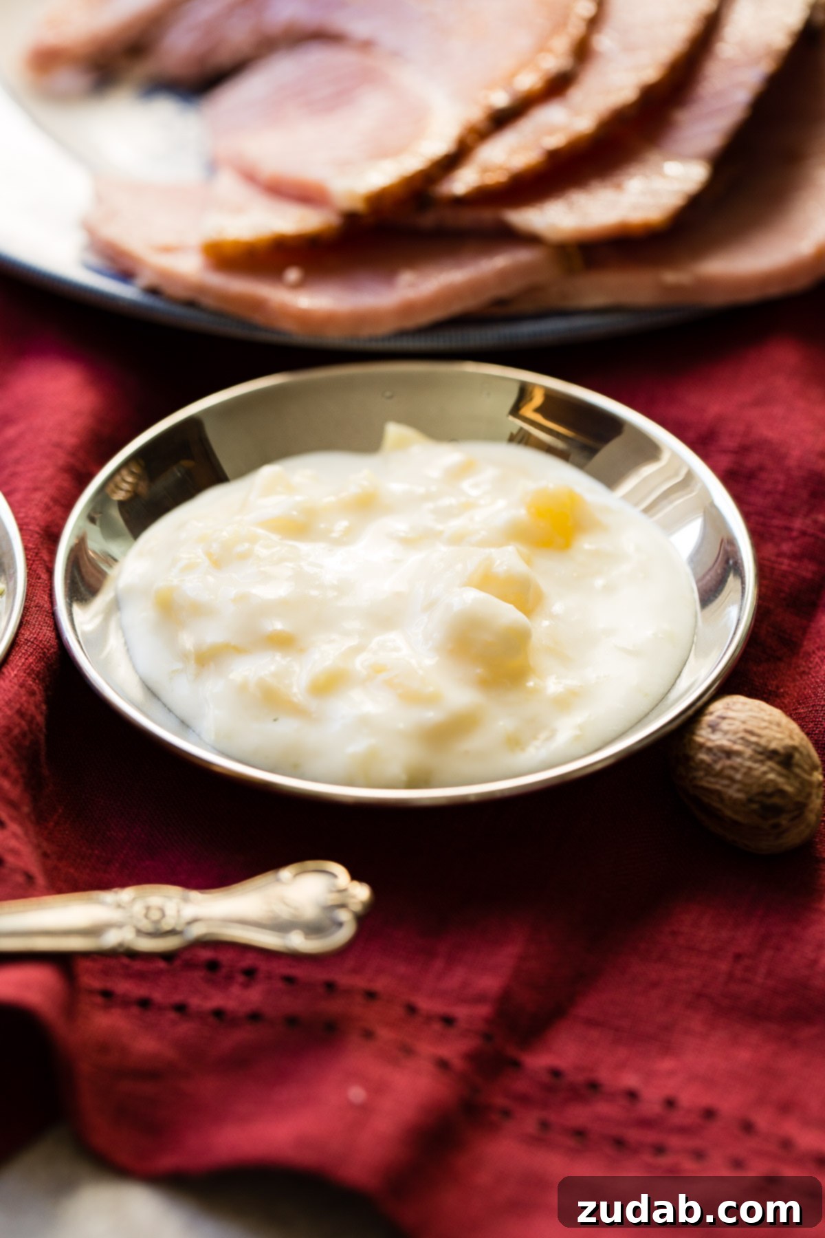 Simple Sauces That Make Ham Shine 11 A small bowl of creamy Pina Colada Ham Dipping sauce, a seriously easy recipe, ready to serve with ham slices.
