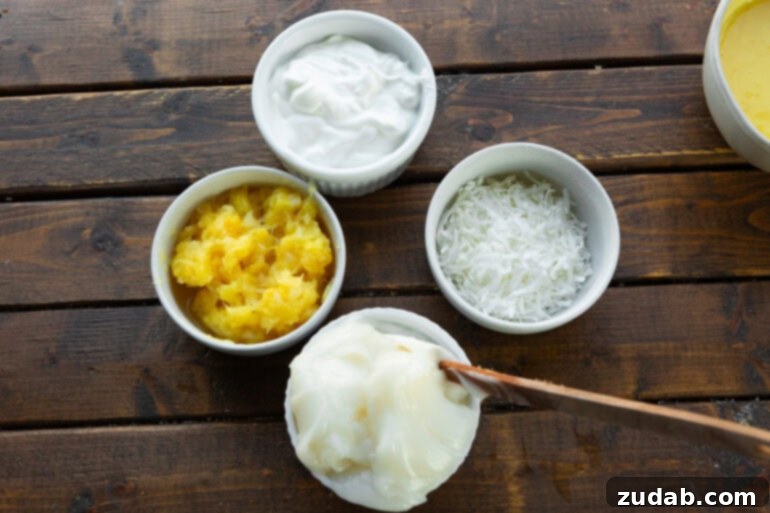 Simple Sauces That Make Ham Shine 5 An overhead view of all the tropical ingredients laid out for a vibrant pina colada dipping sauce, including cream of coconut, sour cream, crushed pineapple, and desiccated coconut, each in its own small dish.