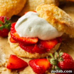 Perfect Homemade Strawberry Shortcake 9 A photo of a golden sweet biscuit filled with juicy strawberry slices and fluffy whipped cream, the ultimate homemade strawberry shortcake.