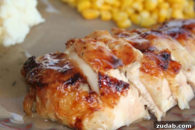 honey roasted chicken ohsweetbasil.com Golden brown Honey Roasted Chicken, perfectly cooked and glistening, served on a platter.