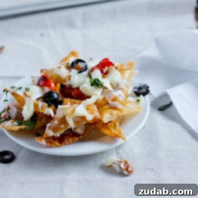 2012's Flavorful Favorites 7 A plate of vibrant Italian Nachos, loaded with melted cheese, Alfredo sauce, and Italian toppings.