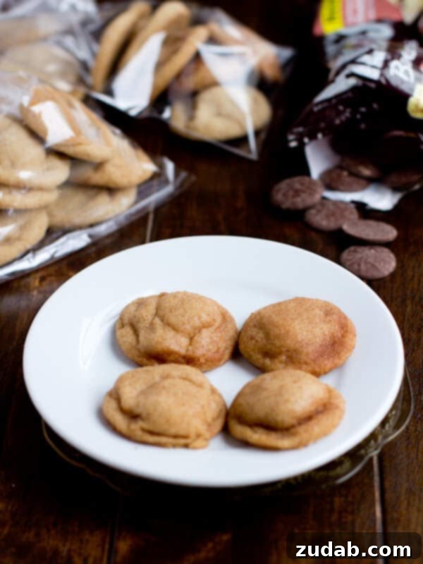 A batch of freshly baked peanut butter meltaway cookies, stacked and ready to enjoy from ohsweetbasil.com