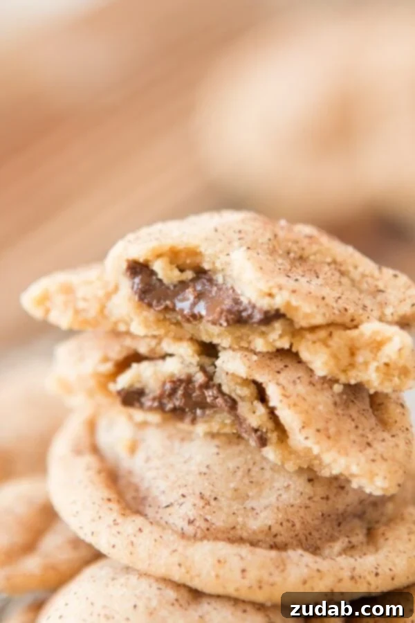 Perfectly round Peanut Butter Meltaway Cookies with visible chocolate filling, cooling on a rack, image by ohsweetbasil.com