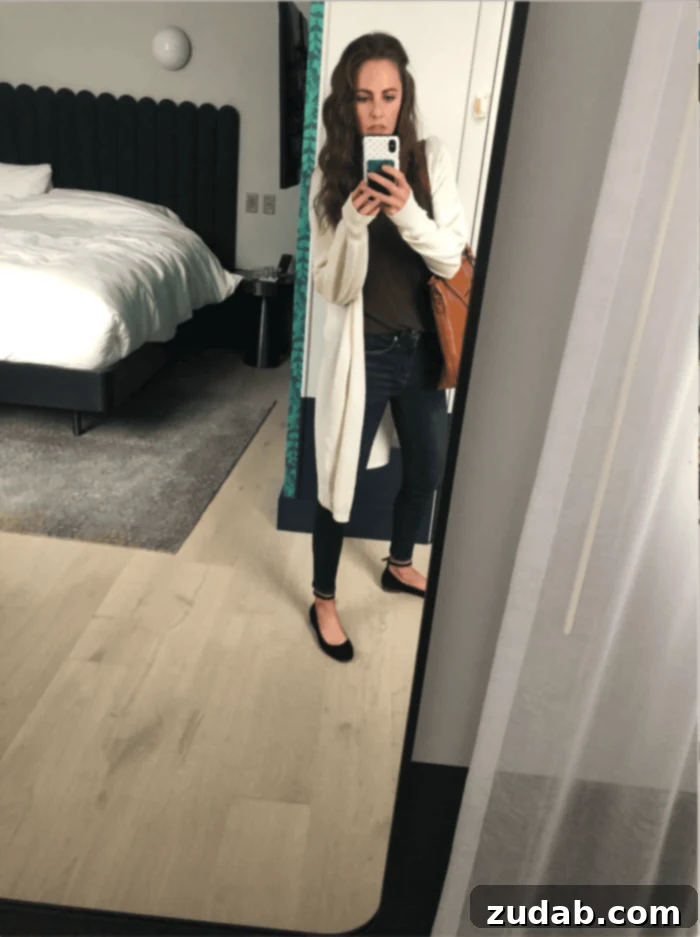 Road Trip Ready Snacks and Entertainment Solutions 13 A mirror selfie taken in a hotel room, showcasing a traveler's personal style and a glimpse of their accommodation during a trip.