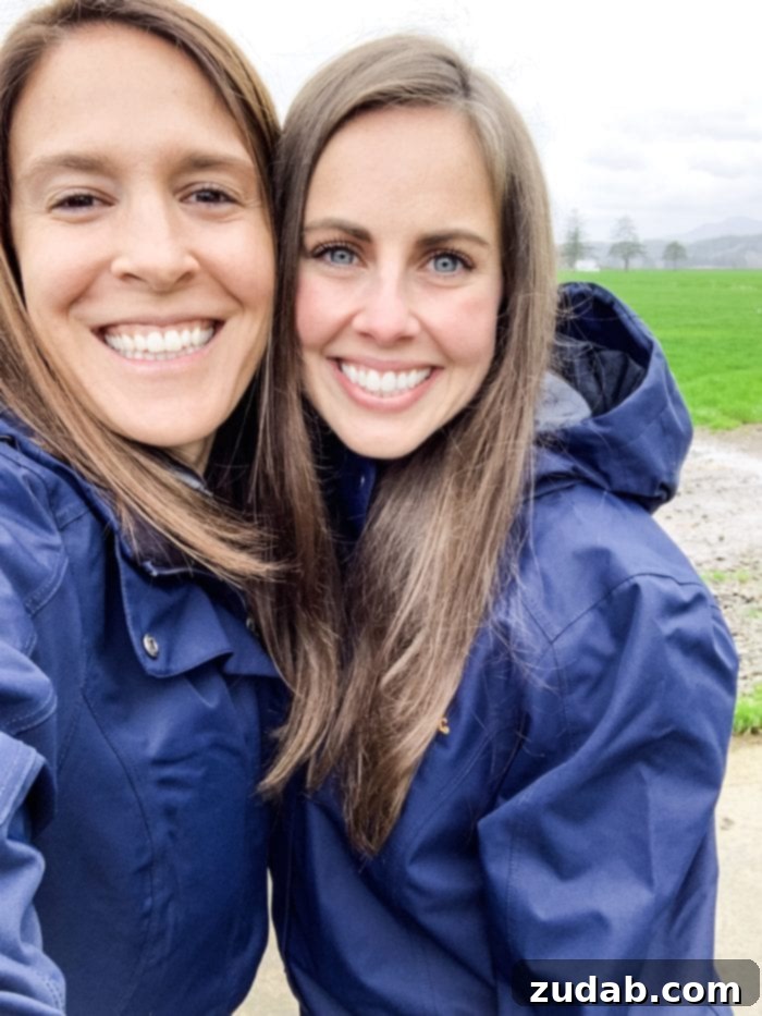 Road Trip Ready Snacks and Entertainment Solutions 14 Two friends are captured smiling genuinely at the camera during their visit to Tillamook Farms in Oregon. The setting appears natural and friendly, reflecting a pleasant shared experience.