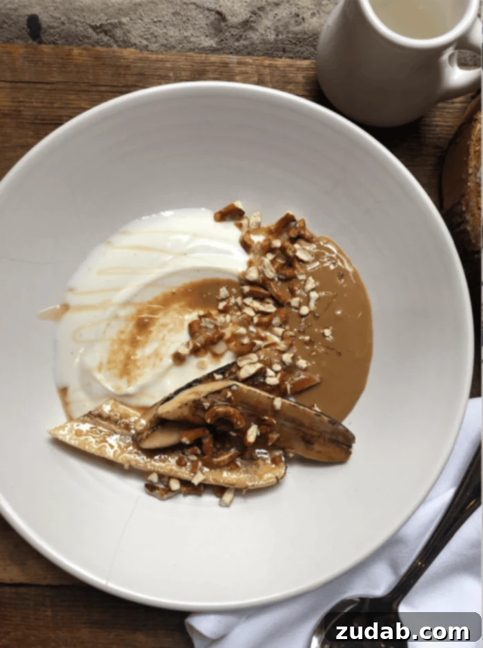 Road Trip Ready Snacks and Entertainment Solutions 15 A beautifully presented yogurt bowl, generously topped with a swirl of rich nut butter, a scattering of finely chopped nuts for texture, and slices of perfectly grilled banana, creating an enticing and healthy breakfast or snack.