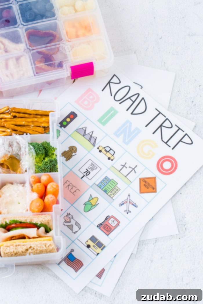 Road Trip Ready Snacks and Entertainment Solutions 5 A free printable sheet for Road Trip Bingo is displayed next to a meticulously organized snack box, which is filled with an assortment of nourishing and healthy snacks. This combination offers both fun and fuel for family travels.