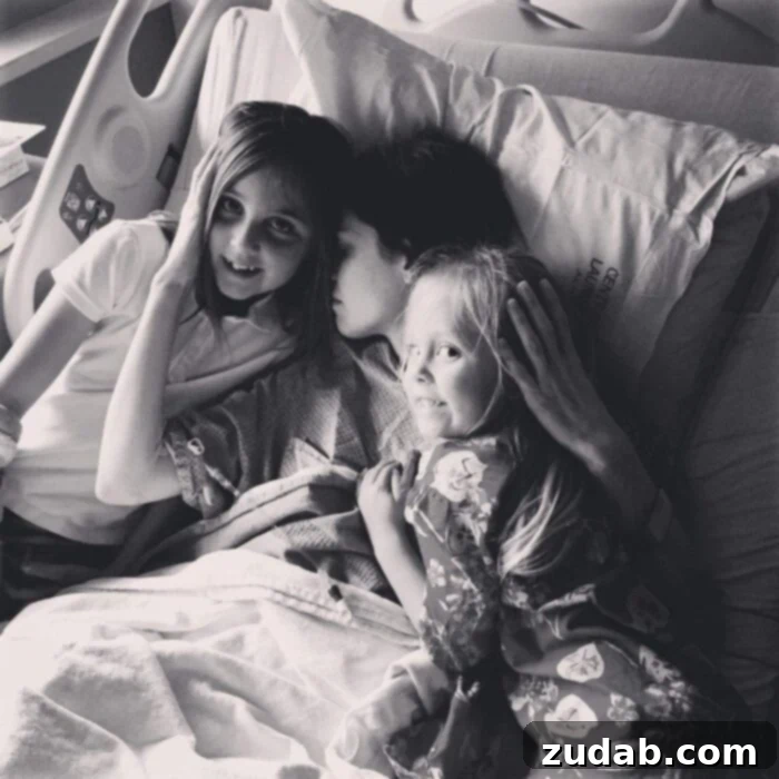 Unyielding Faith in the Abyss 2 A photo of my in a hospital bed snuggling my two girls.