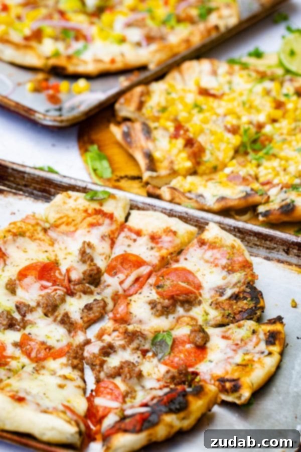 Pesto Pepperoni Grilled Pizza - Oh Sweet Basil A photo of a pesto pepperoni grilled pizza with another grilled pizza topped in the corn in the background.