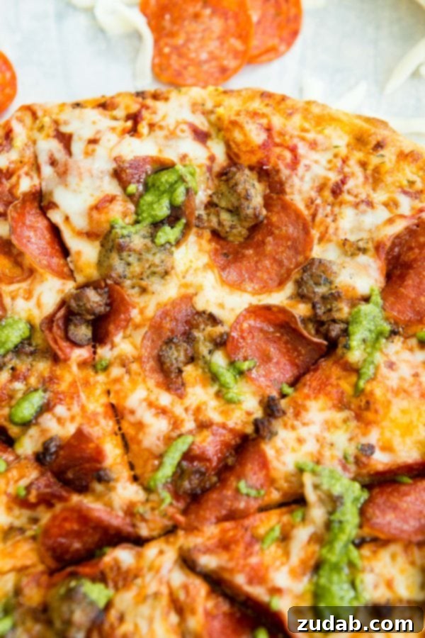Grilled Pesto Pizza with Pepperoni and Sausage 5 A photo of a pesto pepperoni grilled pizza.