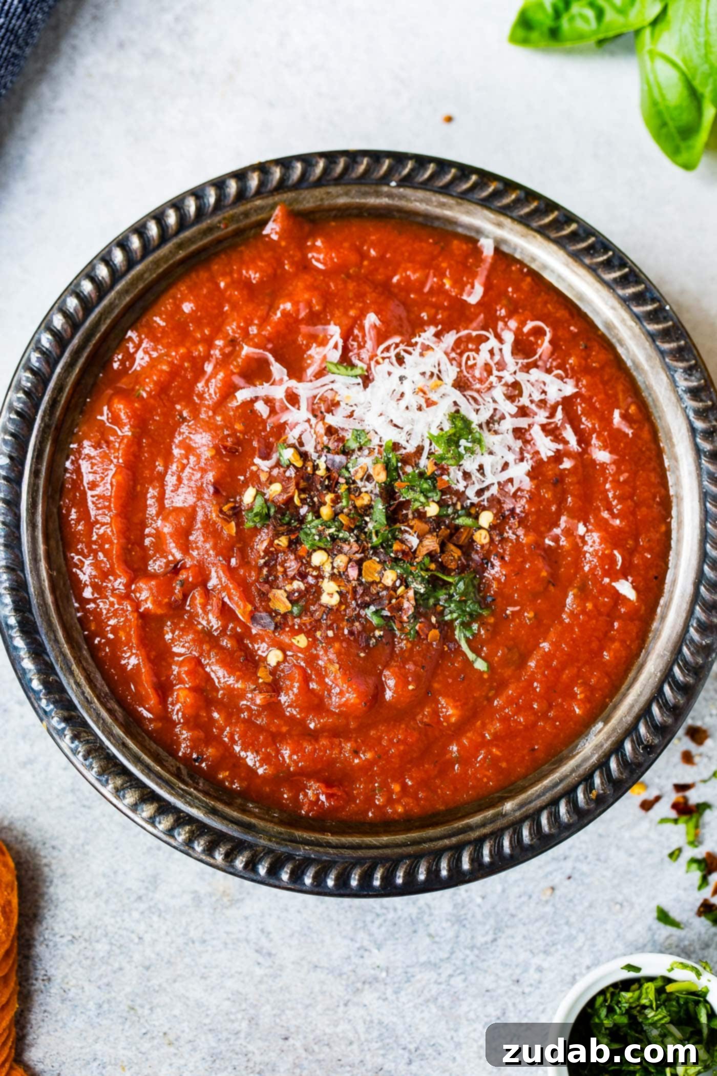 The Simplest Homemade Pizza Sauce You'll Ever Make 5 A bowl of homemade pizza sauce. Cheese and herbs are sprinkled on top.