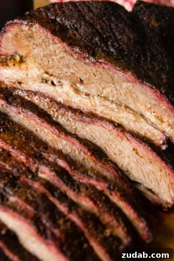 Perfectly Smoked Brisket Recipe A photo of perfectly smoked brisket sliced with a beautiful smoke ring.