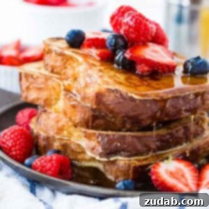 Mastering Perfect French Toast 2 a stack of french toast with maple syrup and berries on top