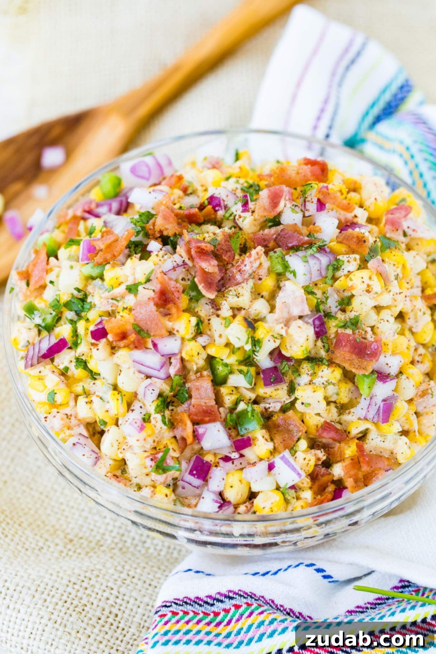 Jalapeno Bacon Elote Mexican Grilled Corn Salad A second close-up view of the vibrant Mexican corn salad, highlighting the texture of the grilled corn, the crispy bacon, and the finely diced jalapenos.