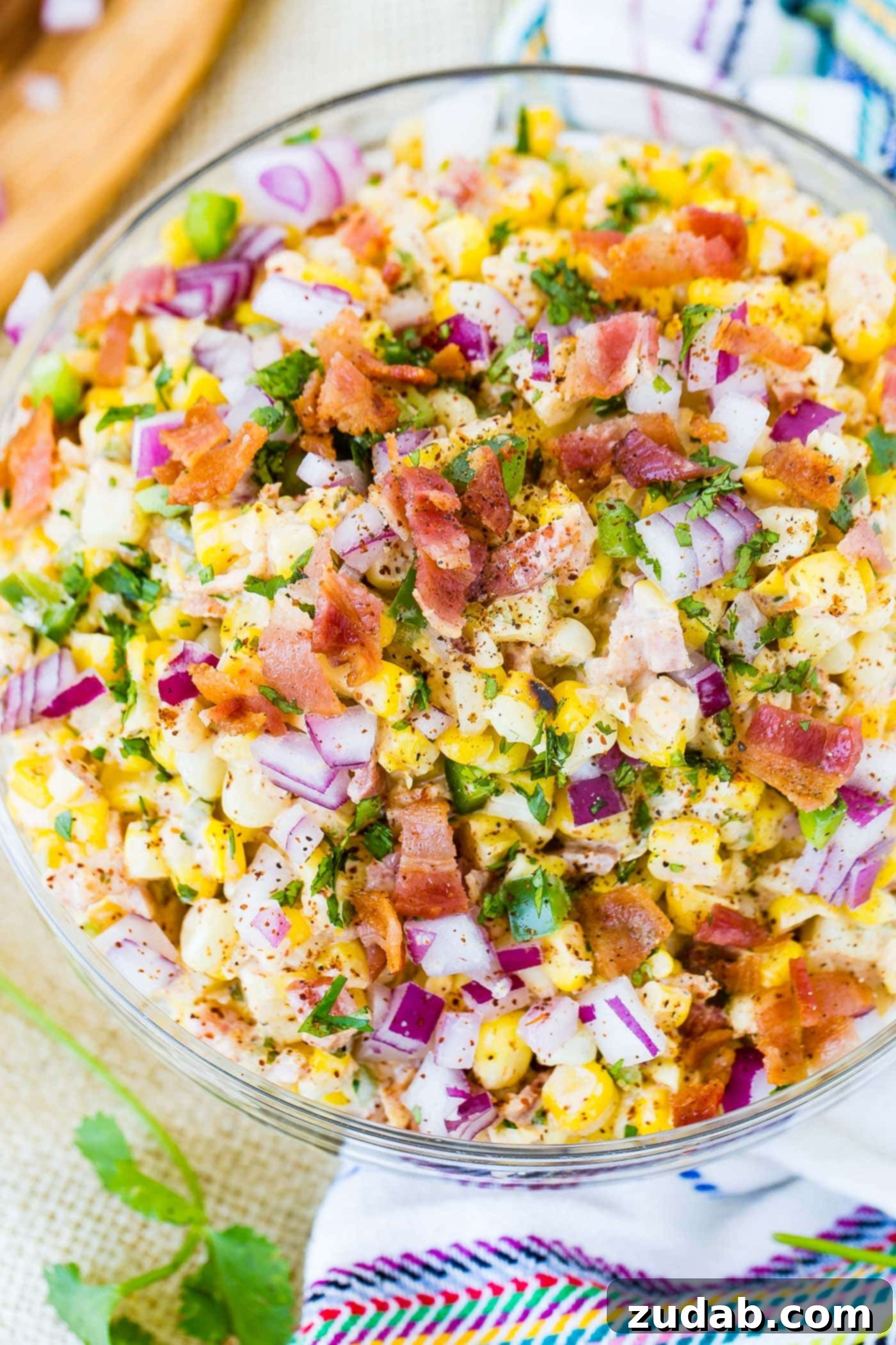 Spicy Bacon Elote Street Corn Salad 2 Another view of the delicious Mexican corn salad, emphasizing the fresh ingredients and the generous toppings of bacon and jalapeno.