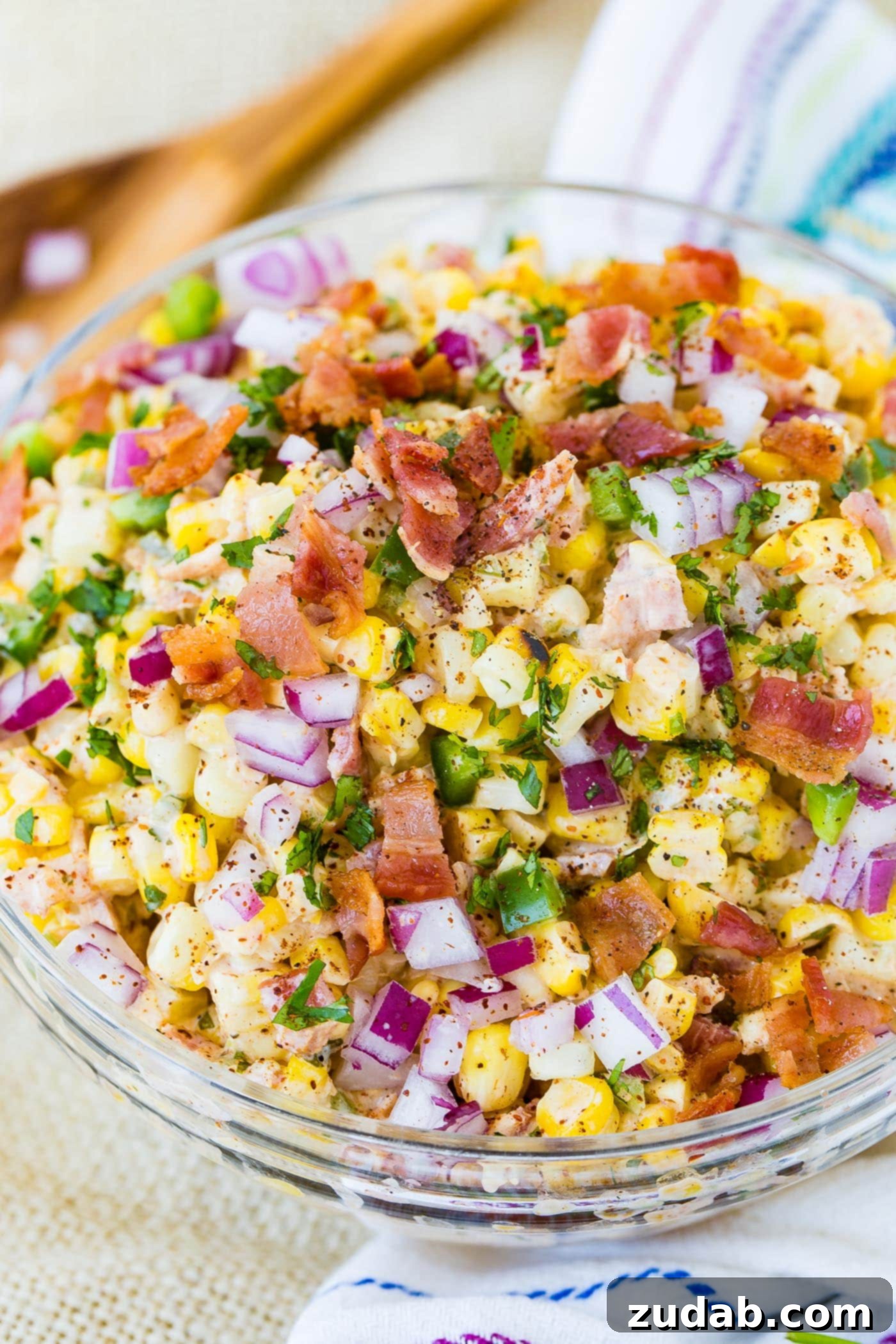 Spicy Bacon Elote Street Corn Salad 3 A beautifully presented bowl of Jalapeno Bacon Elote Mexican Grilled Corn Salad, ready to be served, with visible grilled corn, bacon, and jalapenos.