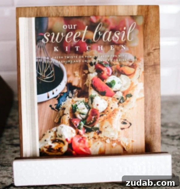 Faith Under Siege in the Shadows Part 26 2 A photo of our cookbook sitting on a wooden stand.