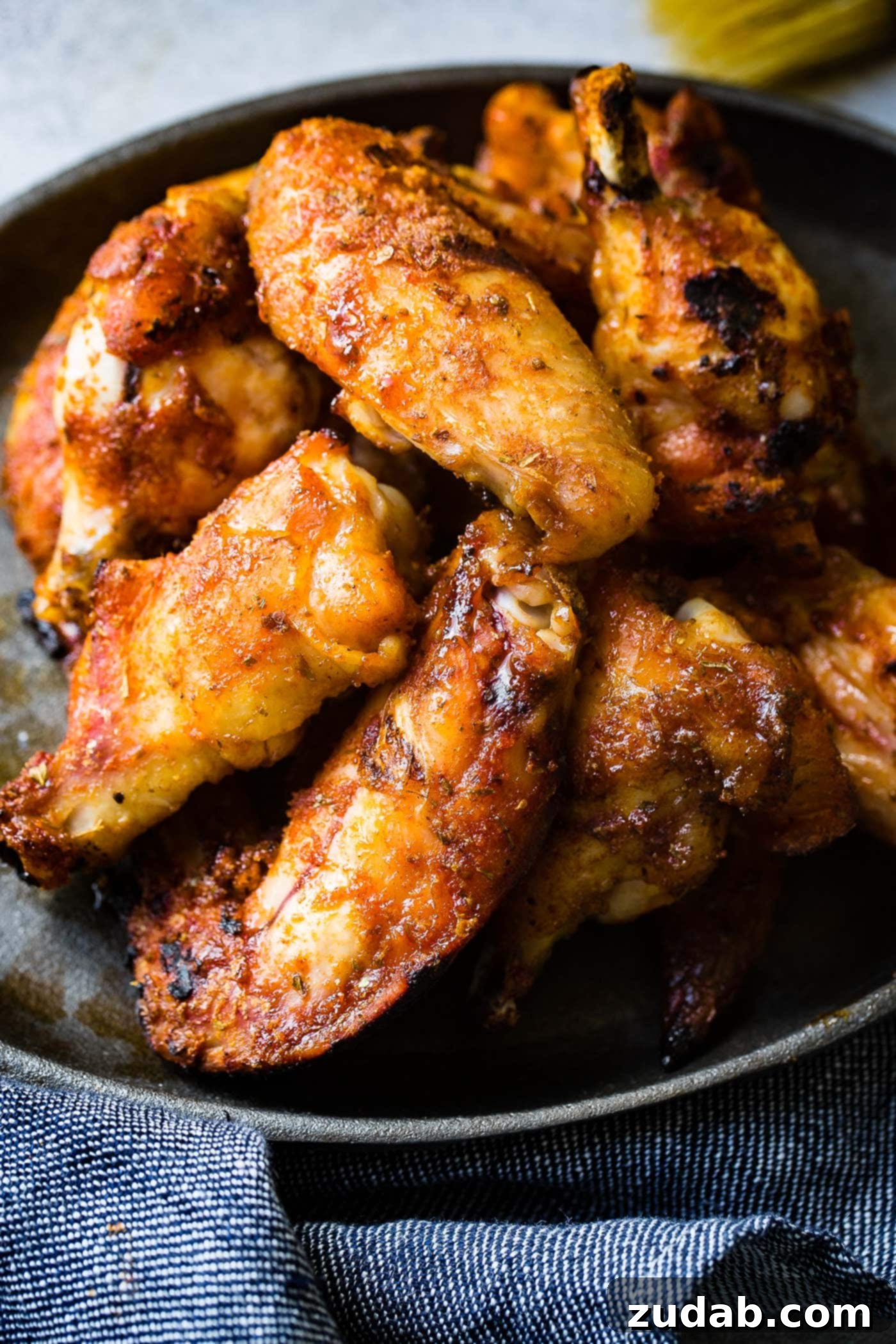 Dry Rubbed Smoked Chicken Wings A photo of a plate full of dry rubbed smoked chicken wings, perfectly cooked and glistening with flavor.