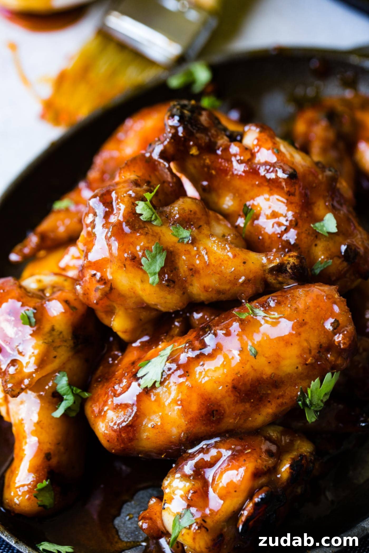 Glazed Smoked Chicken Wings A photo of a pile of glazed smoked chicken wings topped with chopped cilantro.