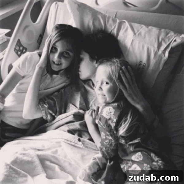 The Shadowed Path: Faith's Unwavering Fight Part 27 3 A photo of my in a hospital bed holding my two girls.