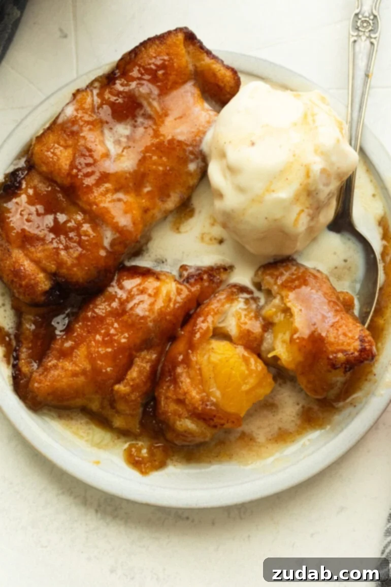Crescent Roll Peach Dumplings with a Sprite Twist 2 a small dessert plate with three golden baked peach dumplings topped with a melting scoop of vanilla ice cream