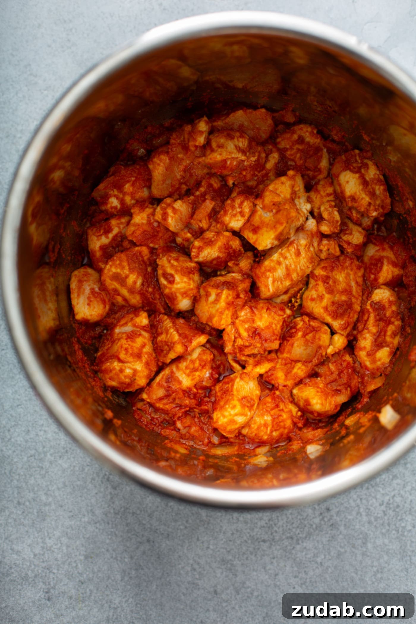 Chicken Curry Recipe in the Instant Pot An instant pot with cubed chicken, carrots, and potatoes in a curry sauce.