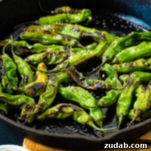 How to Get Perfectly Blistered Shishito Peppers 6 A black cast iron pan with bright green blistered shishito peppers and flaked sea salt