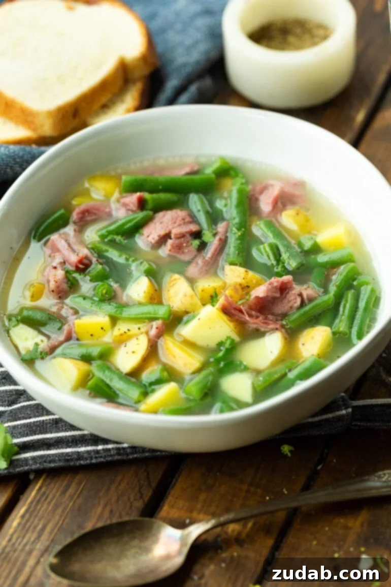 Wholesome Ham Hock Soup: Hearty and Nutritious 2 A photo of a bowl of ham hock and green bean soup, showcasing the hearty vegetables and tender ham chunks.