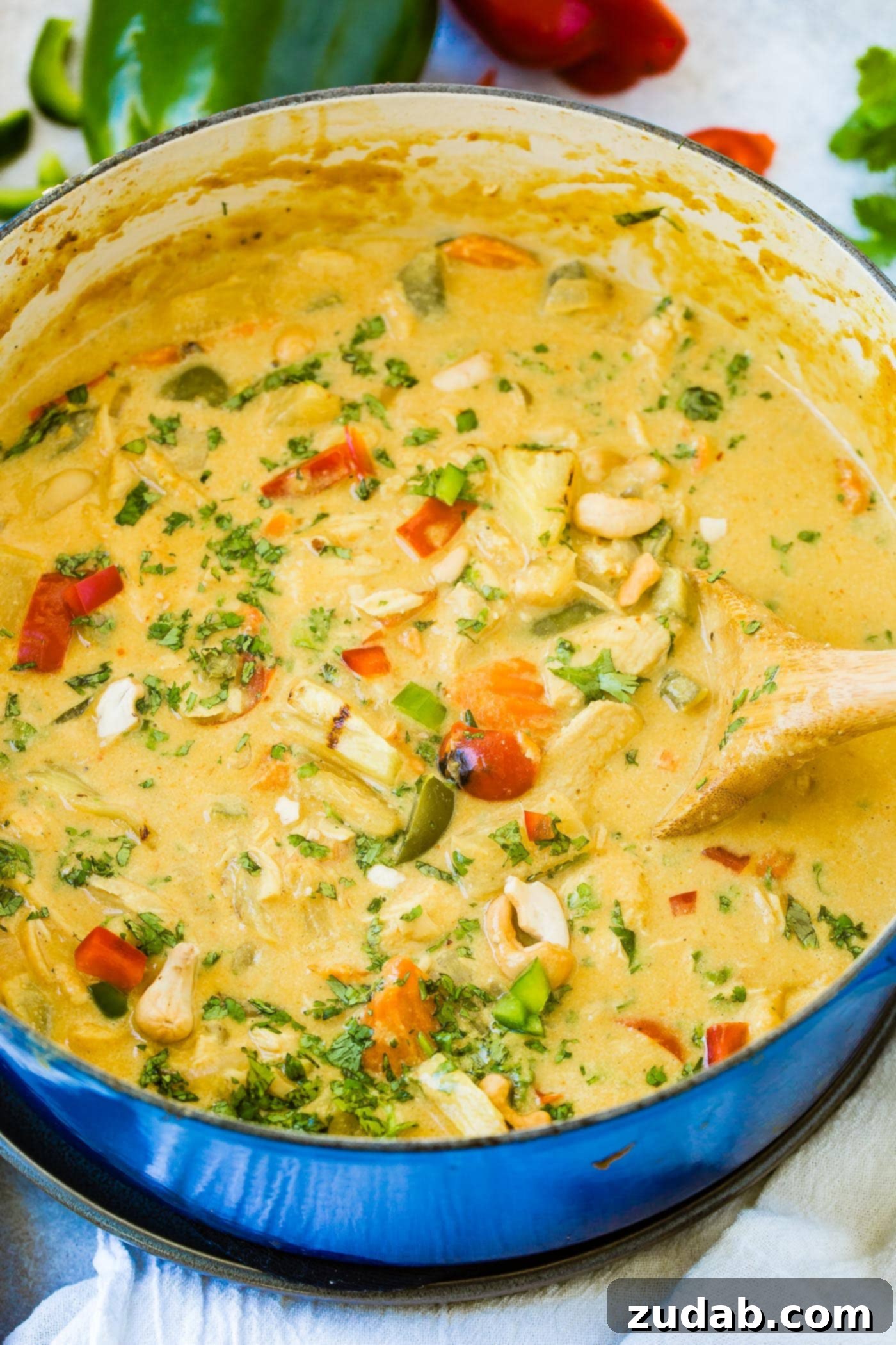 Golden Island Pineapple Coconut Chicken Curry 4 a dutch oven of creamy pineapple coconut chicken curry with peppers, onions and cashews