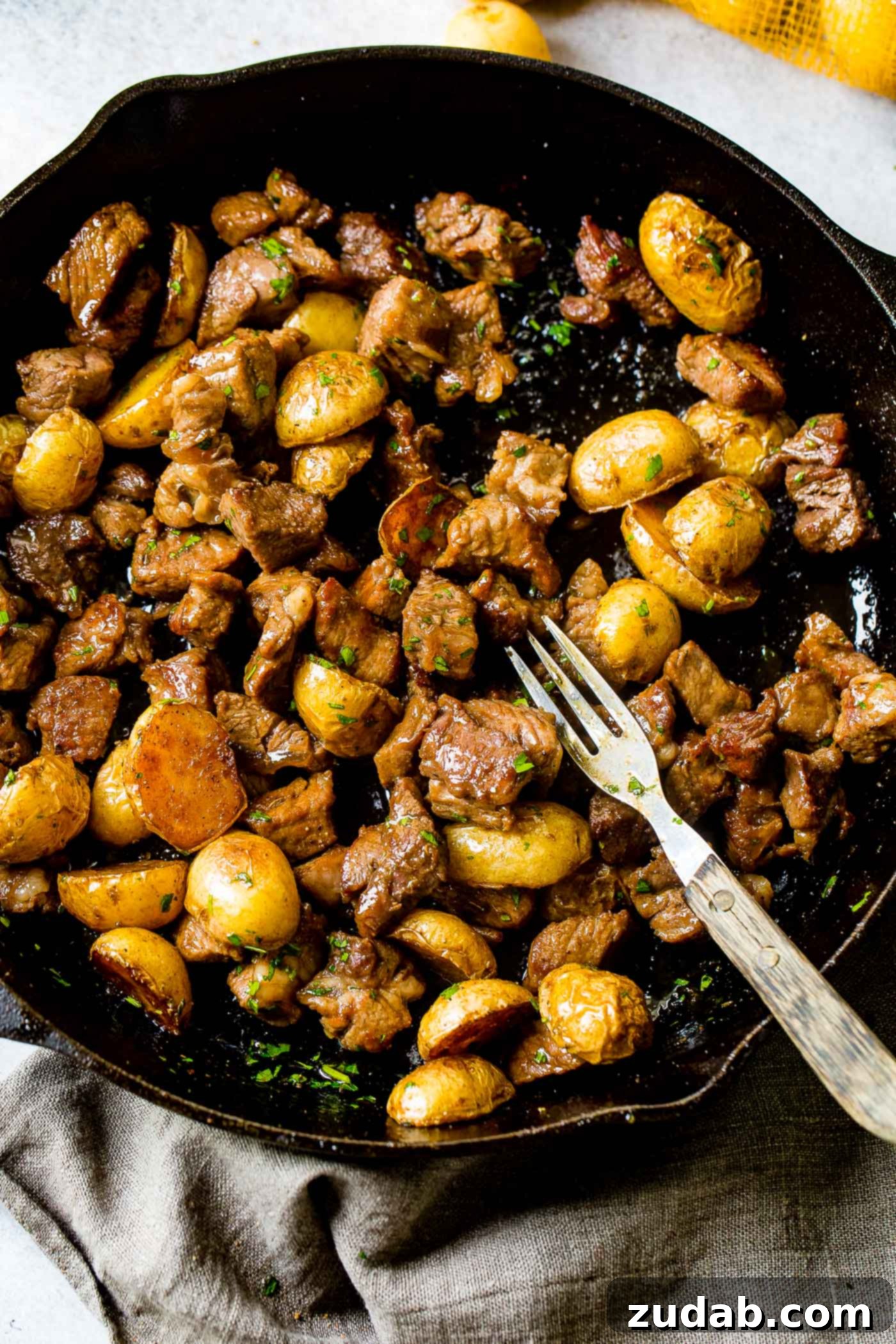One Skillet Smoky Steak and Potatoes A photo of a cast iron skillet full of smoky steak and potatoes, showing the beautiful sear and golden crust.
