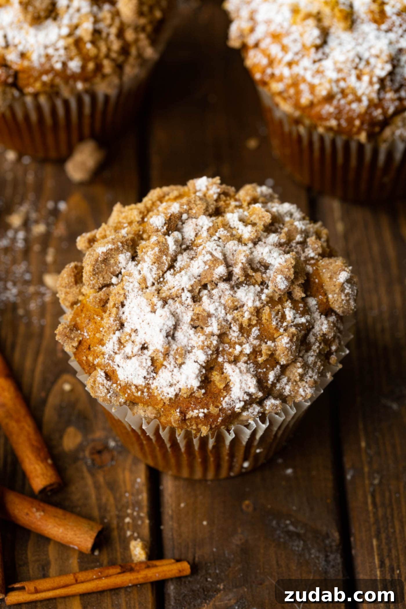 Irresistible Costco Style Pumpkin Streusel Muffins 3 Close-up shot of a perfectly baked jumbo pumpkin streusel muffin, showcasing its golden crumb topping.
