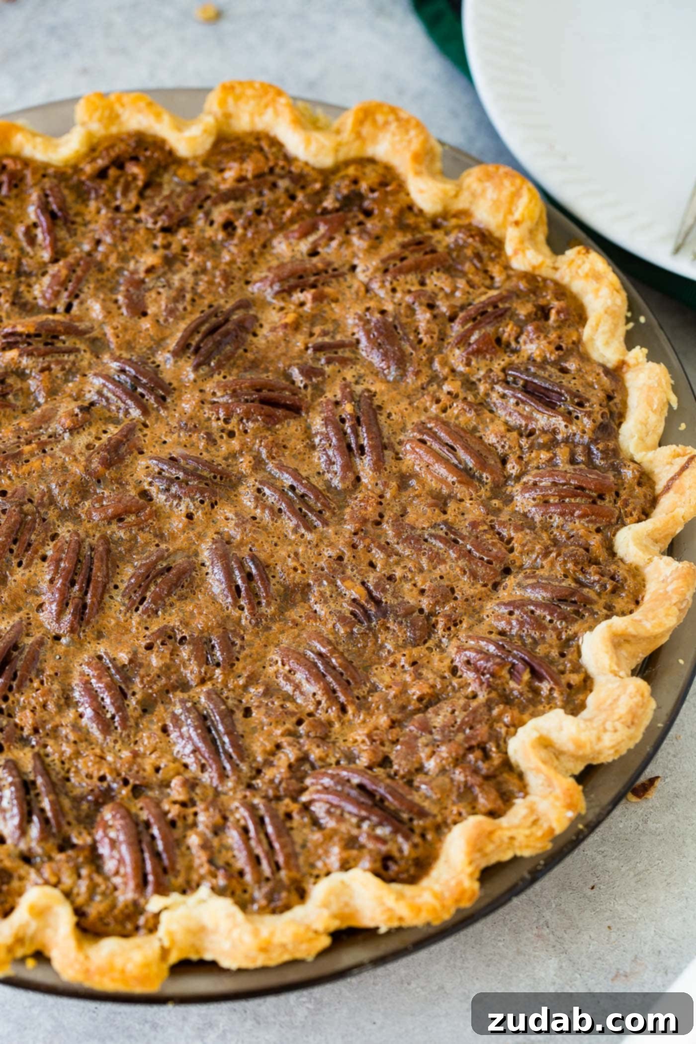 A photo of a whole pecan pie perfectly baked.