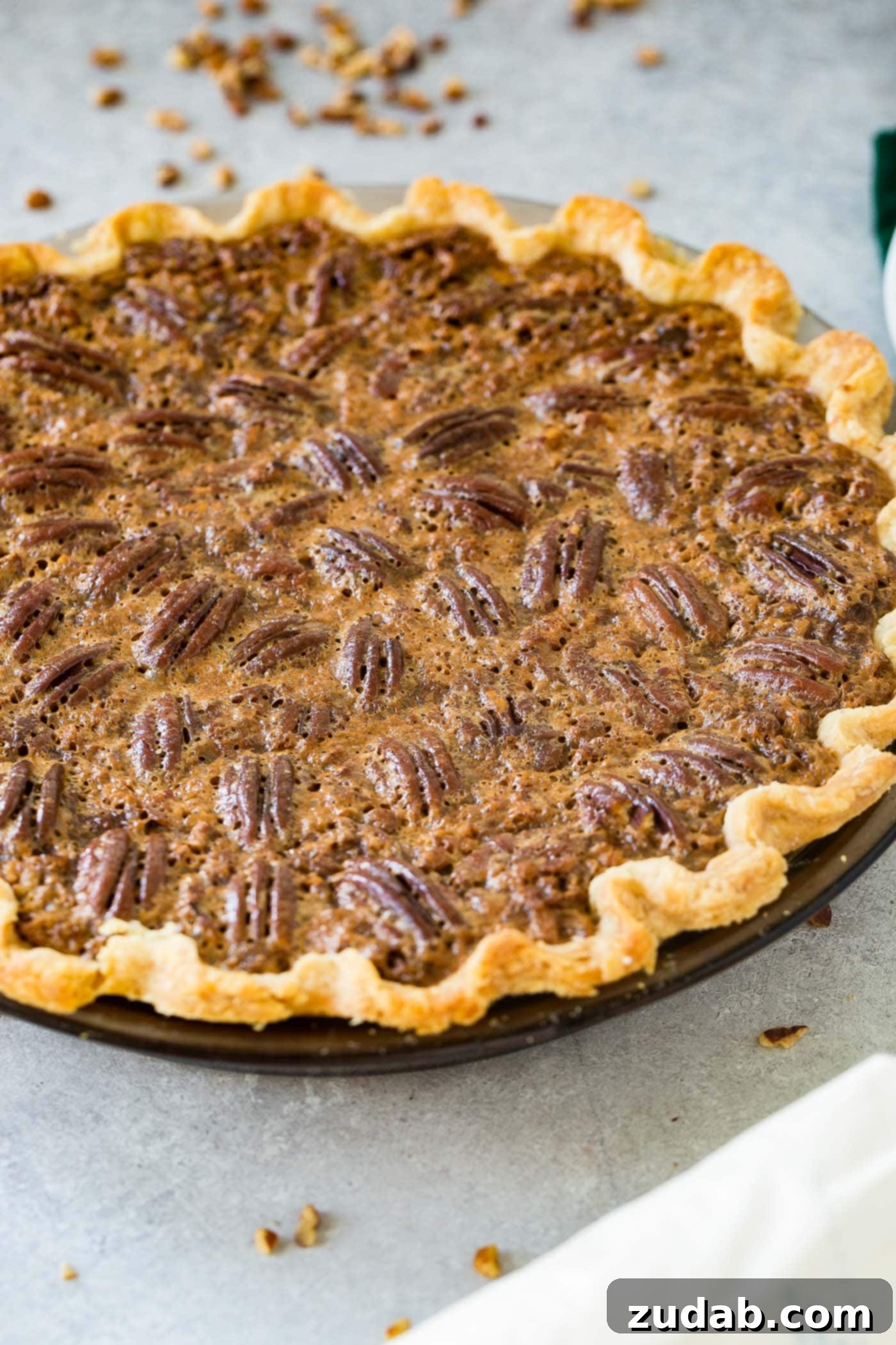 A photo of a whole pecan pie perfectly baked.