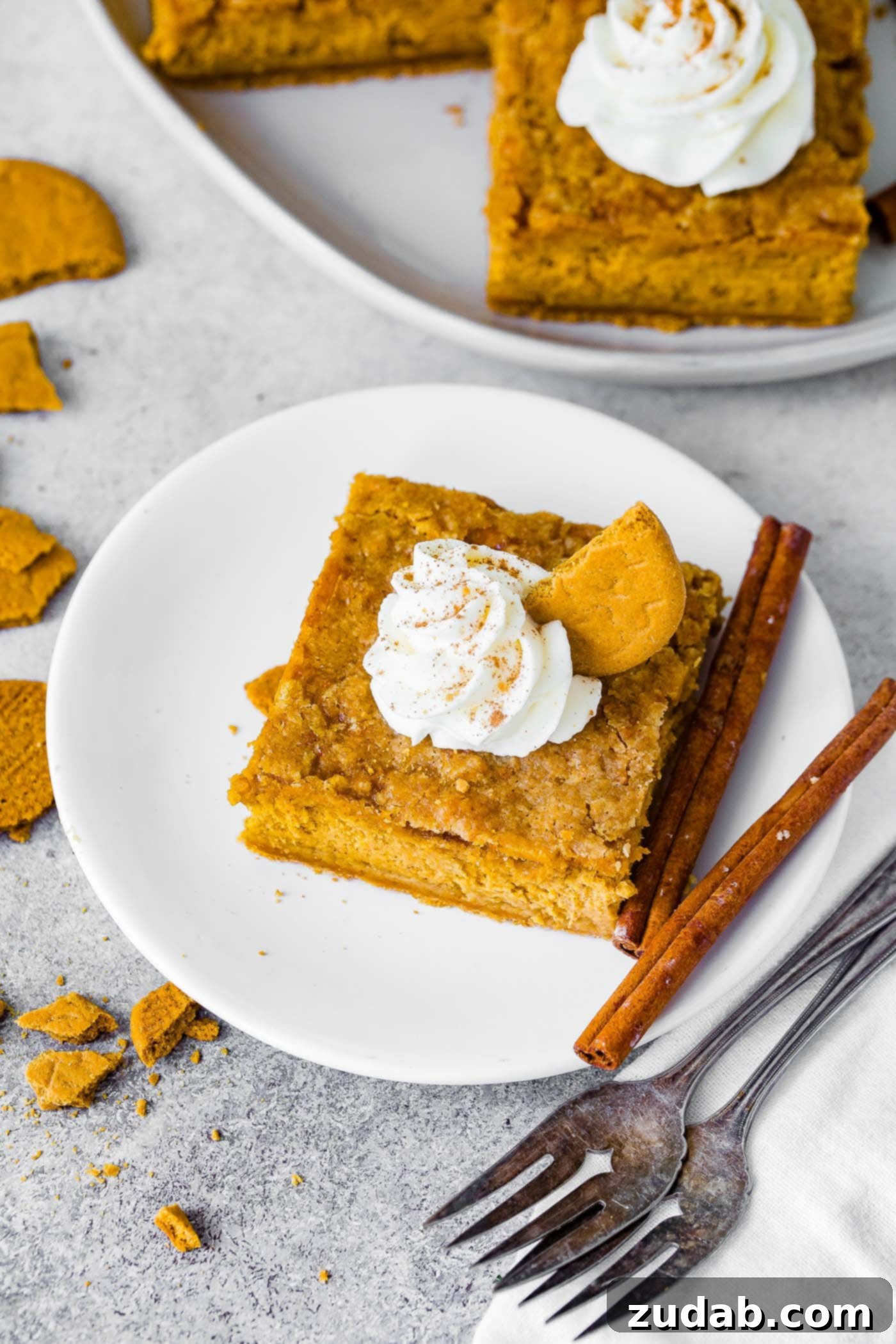 Zesty Gingersnap Pumpkin Cheesecake Delights 5 Ingredients for a homemade pumpkin pie spice blend: cinnamon, ginger, nutmeg, cloves, and allspice arranged in small bowls with measuring spoons.