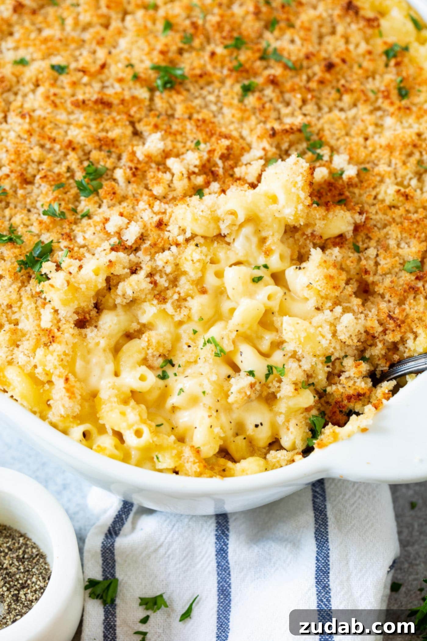 Macaroni and Cheese Perfection 2 A casserole dish with baked mac and cheese, topped with perfectly browned, crispy bread crumbs.