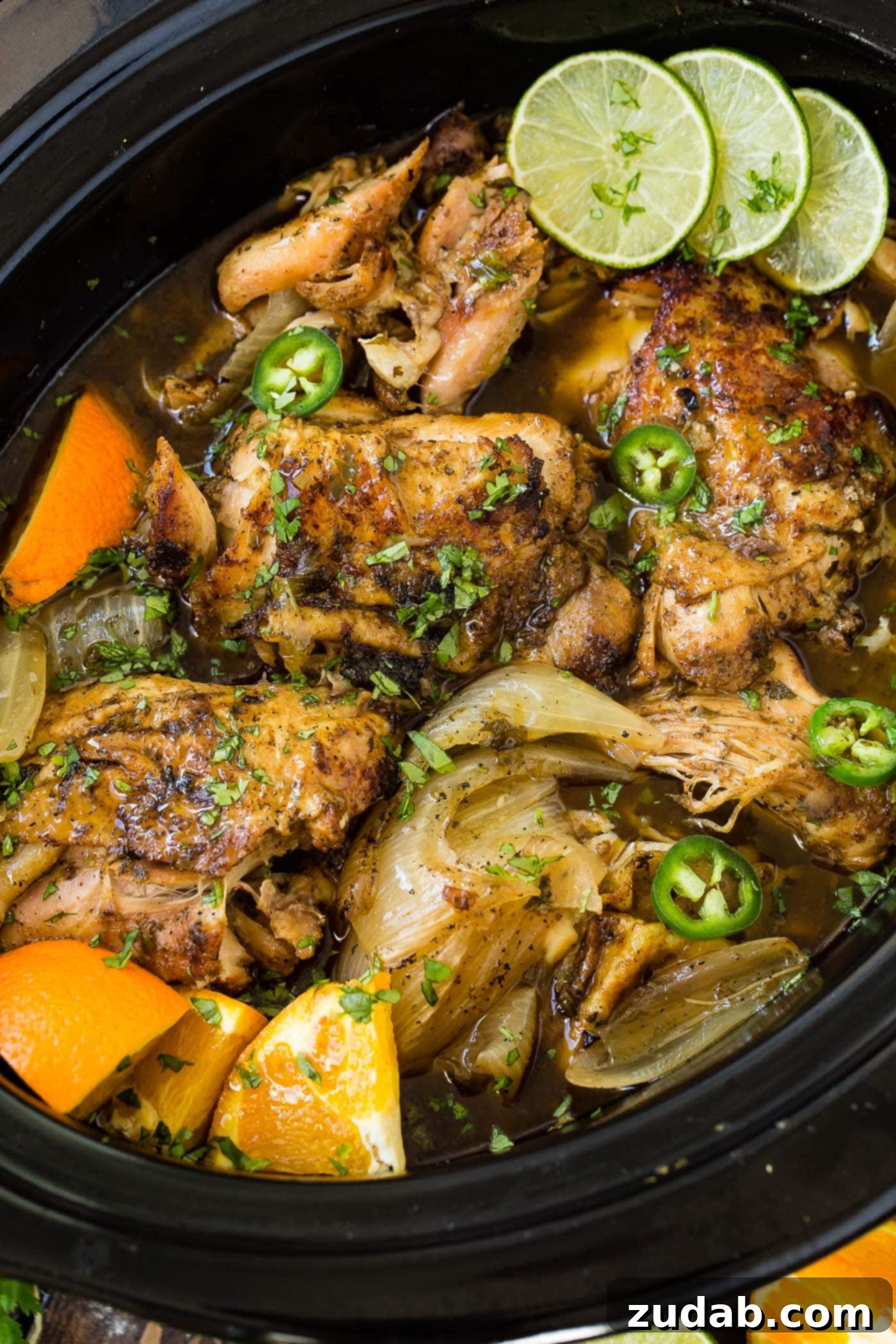 Slow Cooker Chicken Carnitas A photo of chicken carnitas being cooked in a slow cooker.