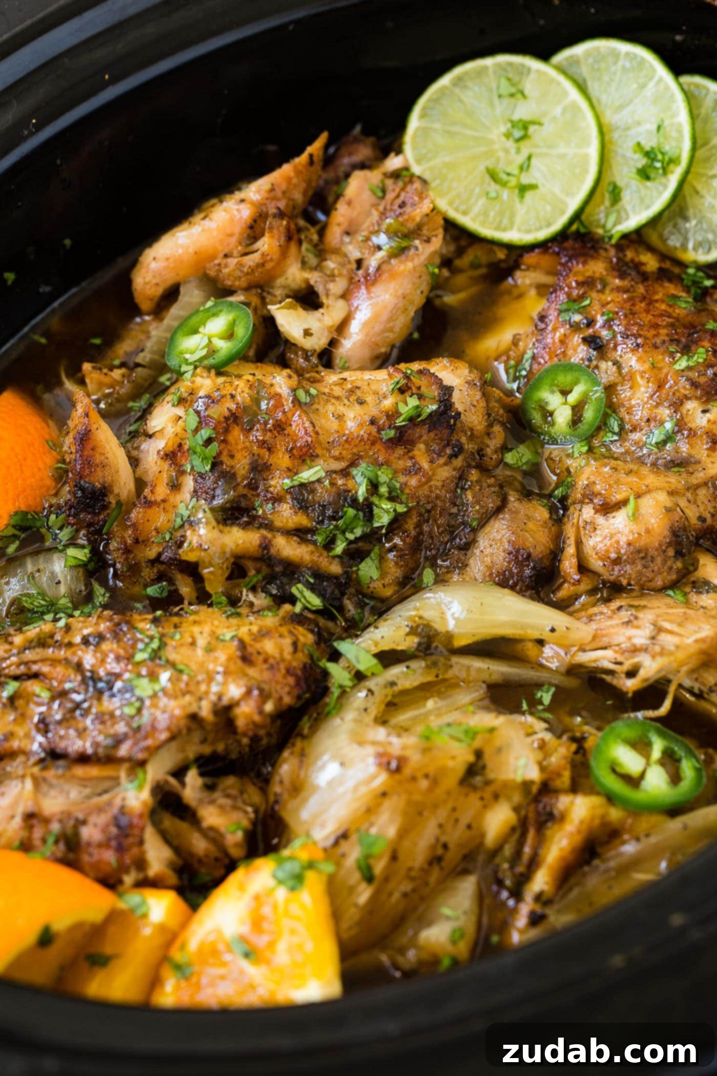 Slow Cooker Chicken Carnitas A photo of chicken carnitas being cooked in a slow cooker.