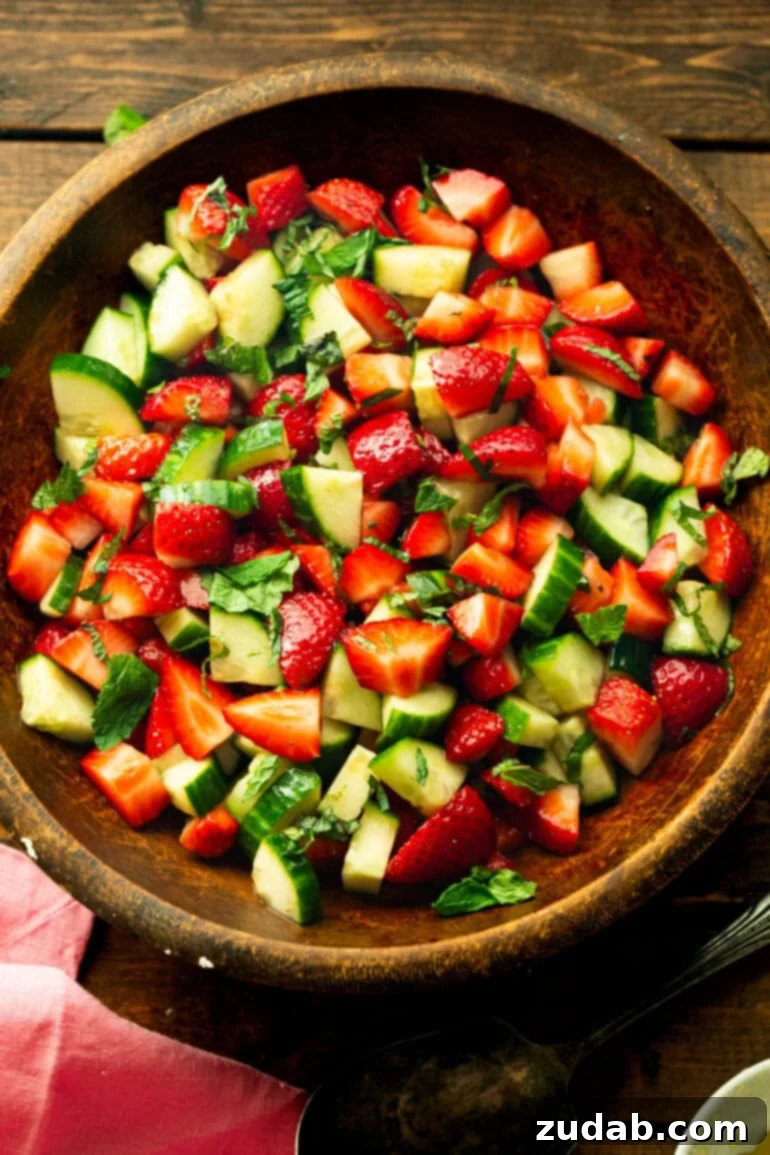Vibrant Strawberry Cucumber Salad with Honey Balsamic 2 a photo of a wooden serving bowl full of strawberry cucumber salad