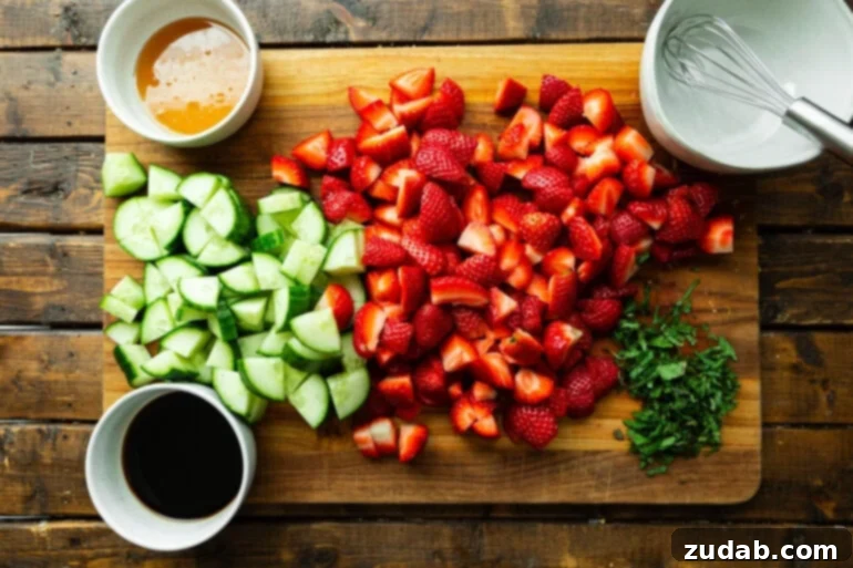 Vibrant Strawberry Cucumber Salad with Honey Balsamic 4 a photo of all the ingredients for strawberry cucumber salad sitting on a wooden cutting board